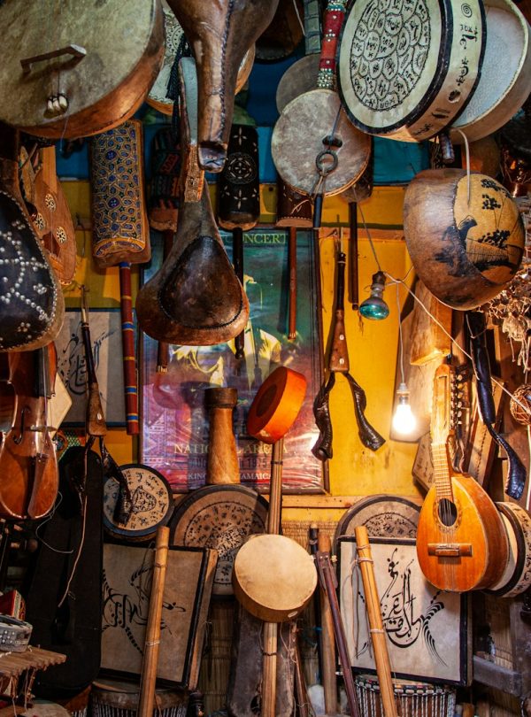 brown wooden guitar hanging on wall